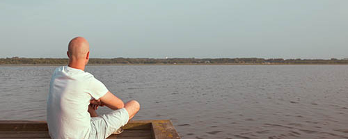 Peaceful man looking at water